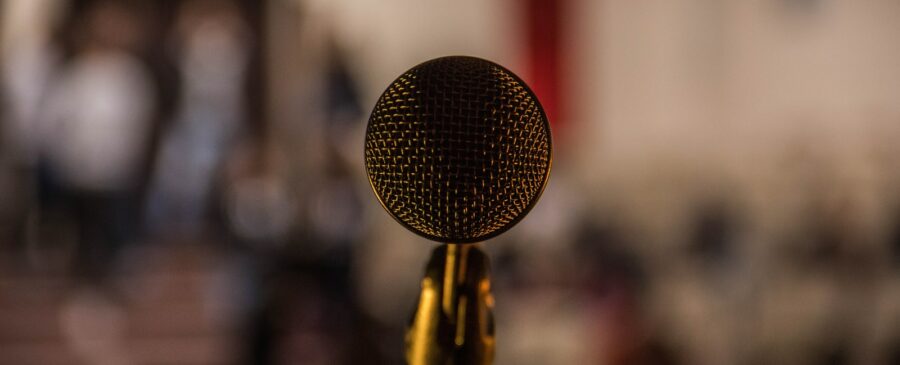 selective focus photography of brass-colored microphone